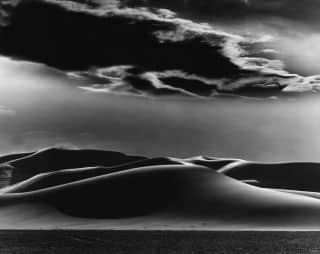 One of our favorite "Dunes" by the prolific Brett Weston. A bit of history behind the photographer - In 1929, Brett and his father moved to Carmel, California where the Weston family, including Brett’s three brothers, would maintain homes for the rest of their lives. At various times, Brett Weston also lived in Los Angeles where he had his own studio and portrait business, and in New York where he was stationed in the army. He later traveled extensively on personal photographic trips to South America, Europe, Japan, Alaska, and Hawaii. Following a 1947 Guggenheim Fellowship which he used to photograph along the East Coast, he moved to Carmel to assist his ailing father, and pursue his fine art work, including wood sculpture that was influenced by his own photographs. brettwestonarchive 
.
.
.
.
.
#brettweston #analogphotography #blackandwhitephotography #gelatinsilverprint #edwardweston #vintagephotography #danzigergallery #danzigergalleries #danzigergallerylosangeles #adaa #aipad #aperturefoundation #aperture #bergamotstation #santamonica #santamonicagalleries #losangelesgalleries #newyorkgalleries